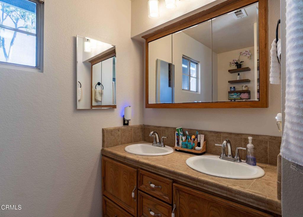 635 East Pleasant Valley Road Port Hueneme, CA 93041 - Photo 16 of 17 a bathroom with a double vanity sink and a mirror