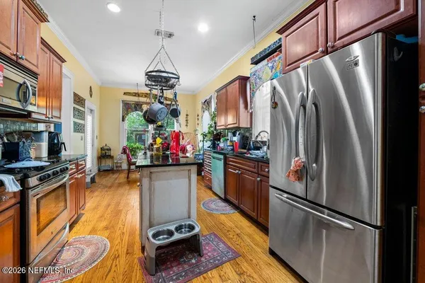 a kitchen with stainless steel appliances granite countertop a refrigerator stove and sink