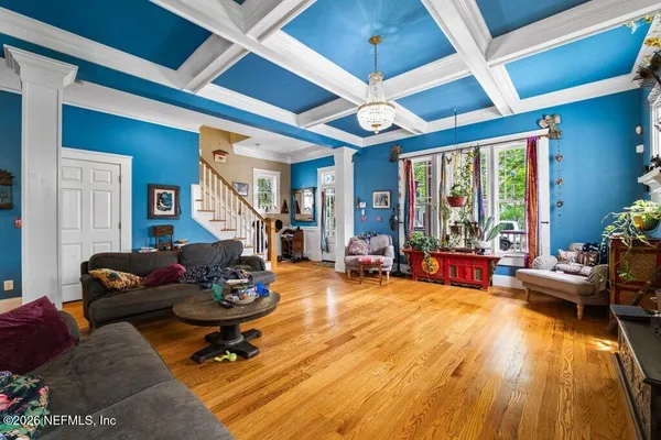 a living room with furniture gym equipment and a large window