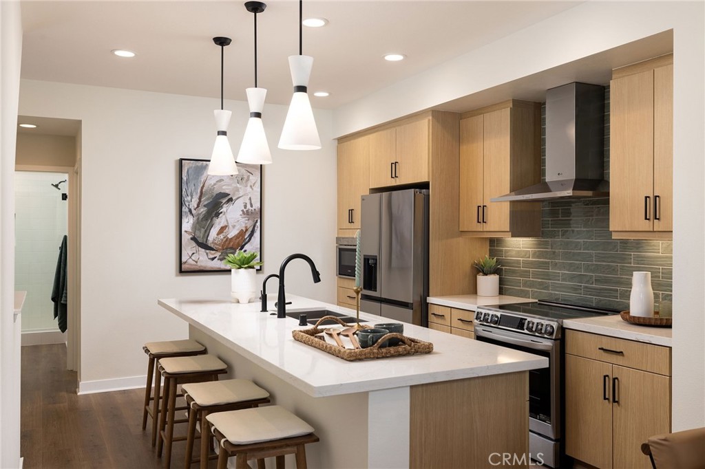 102 South Orchid El Cajon, CA 92019 - Photo 4 of 22 a kitchen with stainless steel appliances kitchen island a sink stove and refrigerator