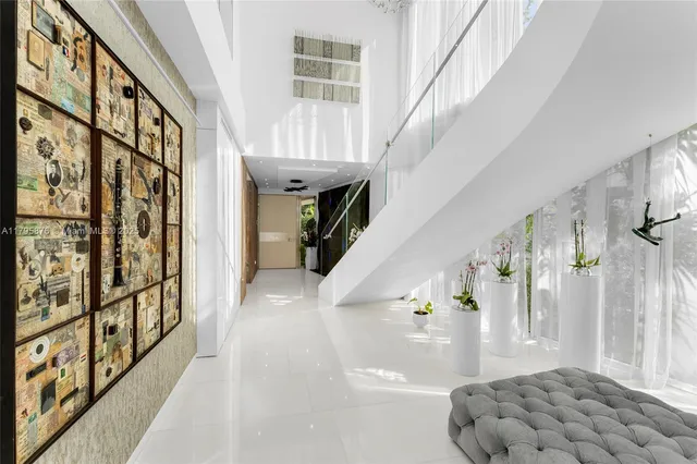 a living room with furniture fireplace and large windows