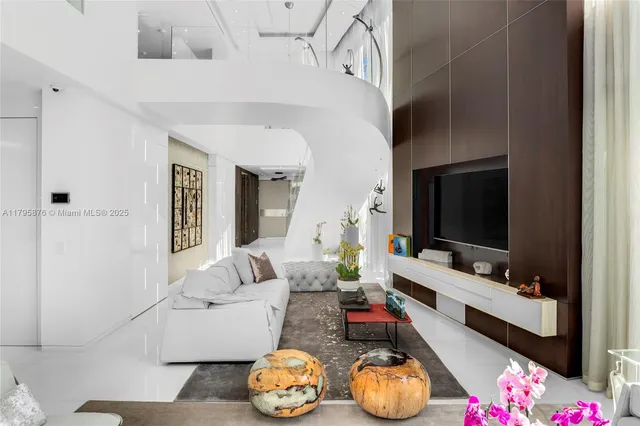 a bedroom with a large bed and a flat tv screen