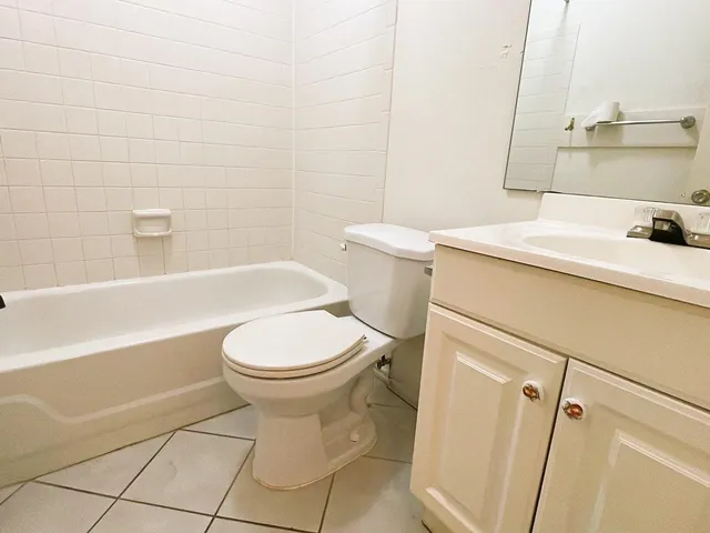 a bathroom with a sink a toilet and bathtub