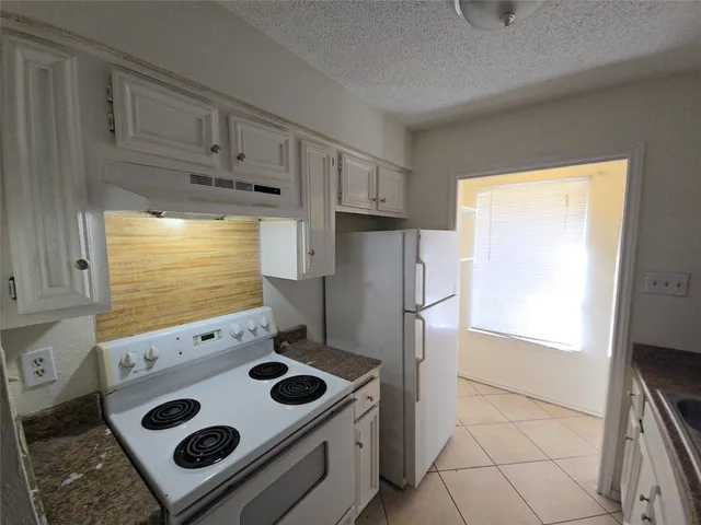a kitchen with a stove and a refrigerator
