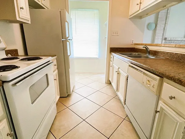 a kitchen with a stove top oven and sink