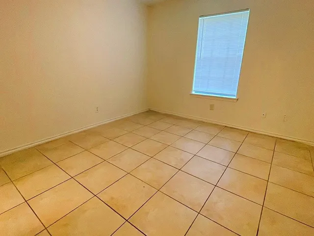 a view of an empty room and a window