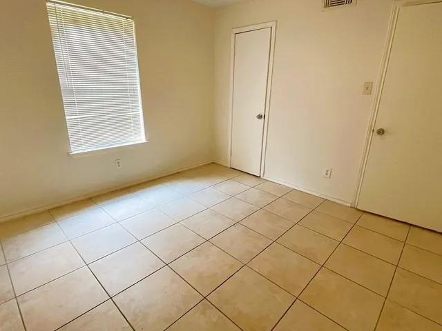 a view of an empty room and a window