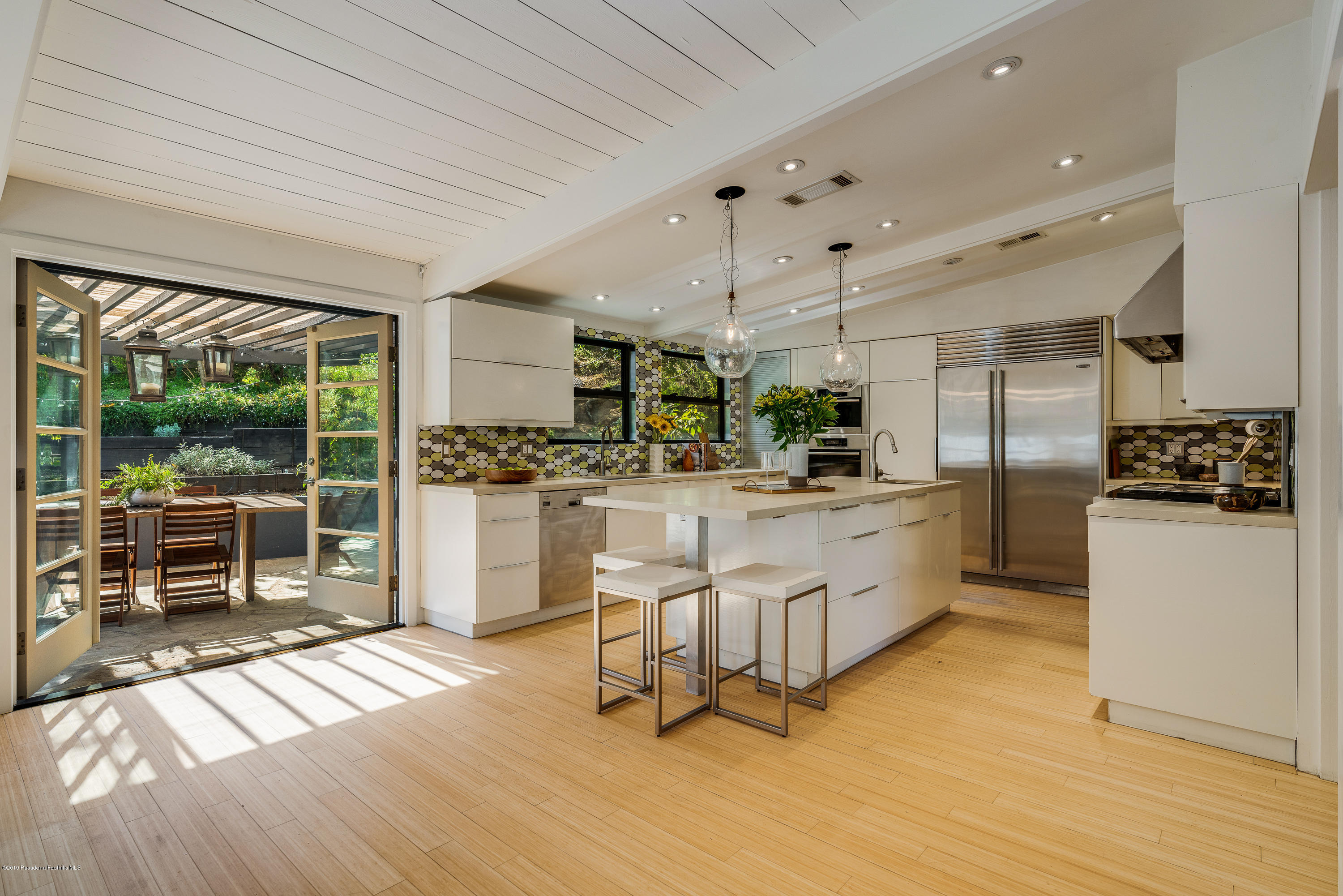 1655 Pleasant Way Pasadena, CA 91105 - Photo 7 of 37 a kitchen with white cabinets and stainless steel appliances