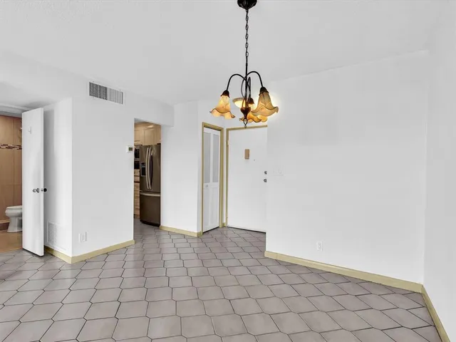 a view of hallway with chandelier and entryway