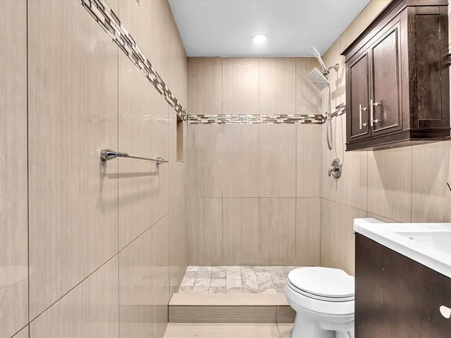 a bathroom with a toilet and a shower