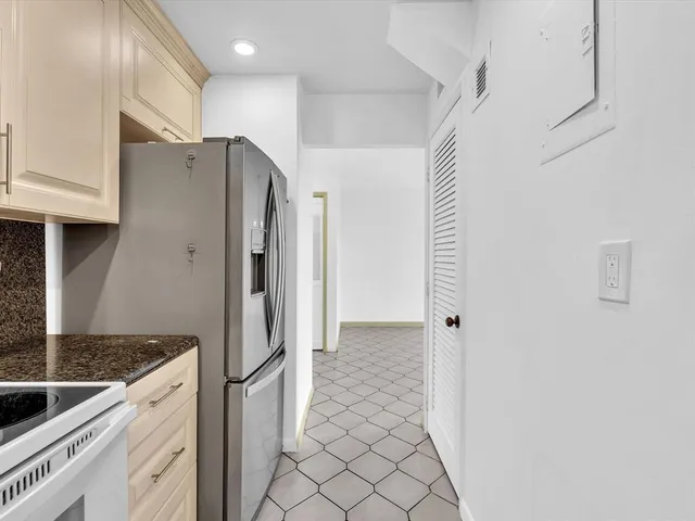 a kitchen with stainless steel appliances granite countertop a refrigerator and a sink