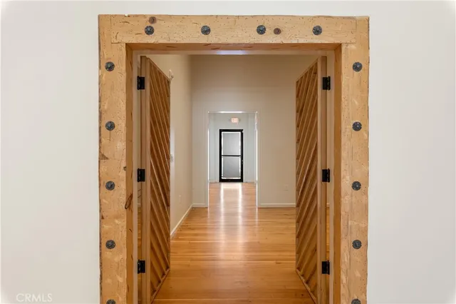 a view of a livingroom with wooden floor and a flat screen tv