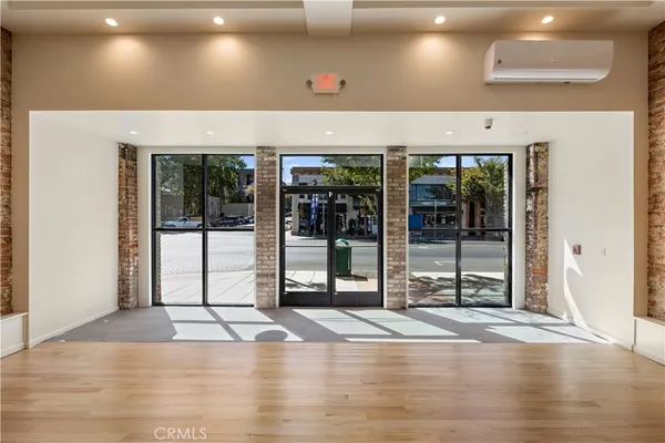 a view of a room with wooden floor and fan