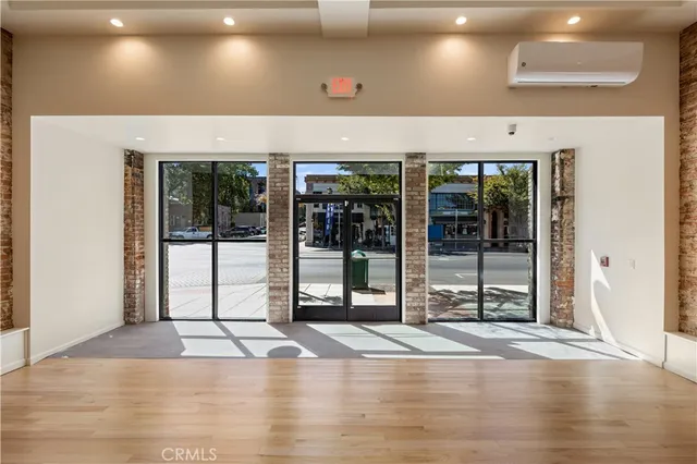 a view of a room with wooden floor and fan
