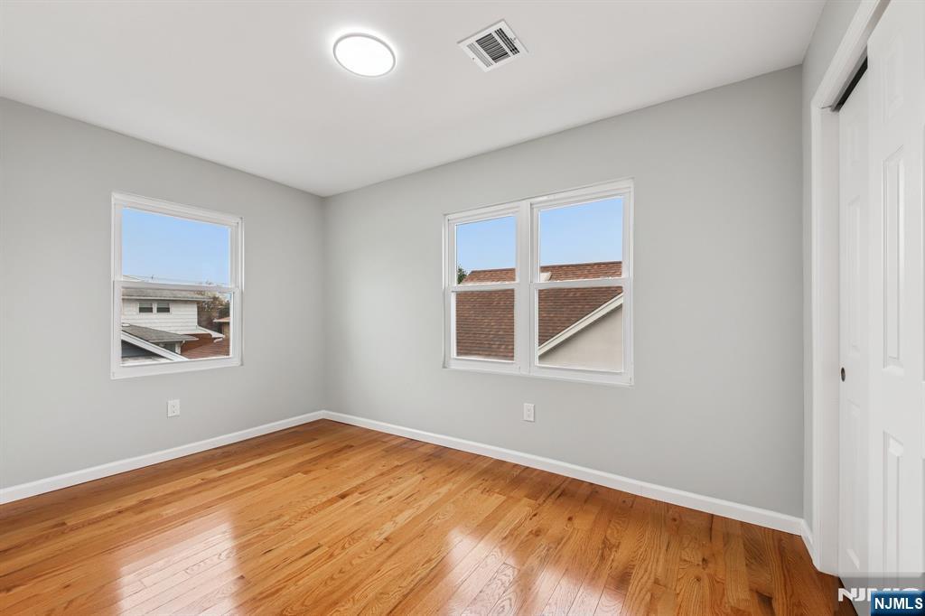 271 North Avenue Wood-Ridge, NJ 07075 - Photo 12 of 18 a view of an empty room with wooden floor and a window