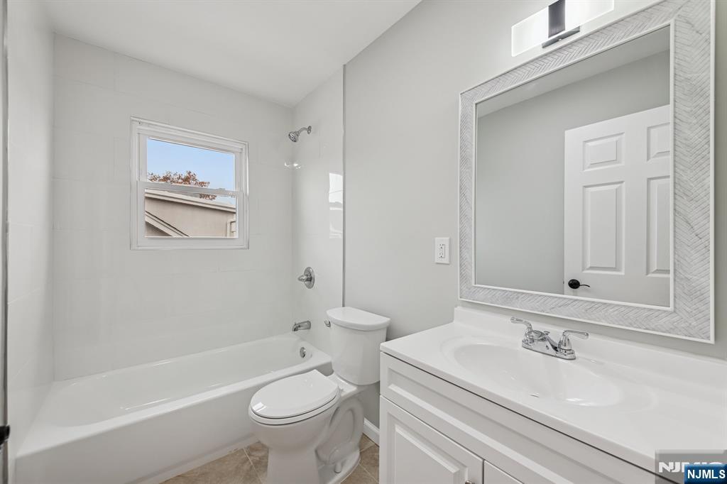 271 North Avenue Wood-Ridge, NJ 07075 - Photo 13 of 18 a bathroom with a sink a toilet and a bathtub