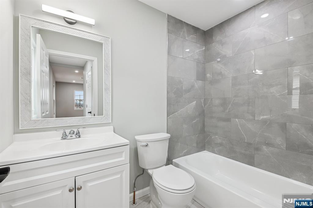 271 North Avenue Wood-Ridge, NJ 07075 - Photo 15 of 18 a bathroom with a sink a toilet and shower