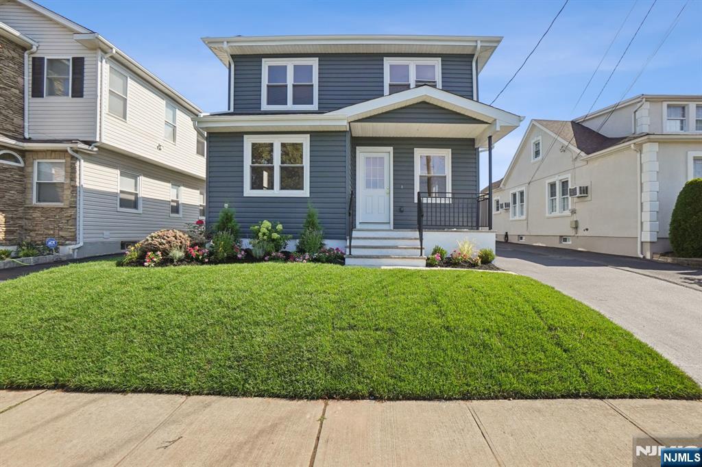 271 North Avenue Wood-Ridge, NJ 07075 - Photo 2 of 18 a front view of a house with garden