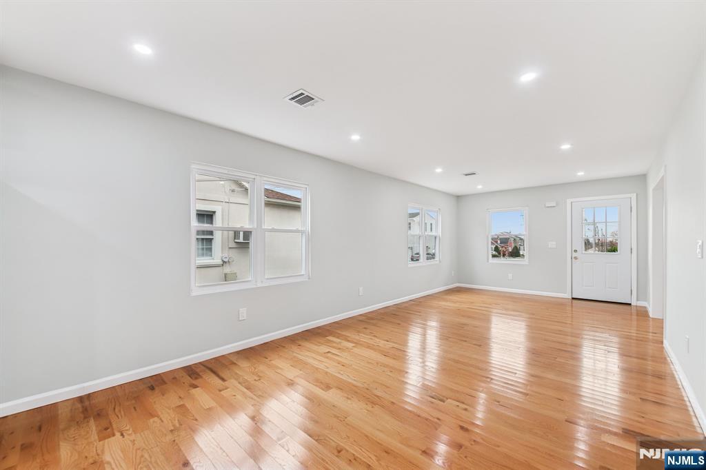 271 North Avenue Wood-Ridge, NJ 07075 - Photo 6 of 18 a view of empty room with wooden floor and fan