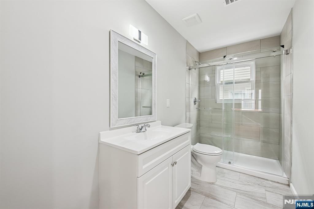 271 North Avenue Wood-Ridge, NJ 07075 - Photo 8 of 18 a bathroom with a sink a toilet and shower