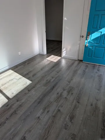 an empty room with wooden floor