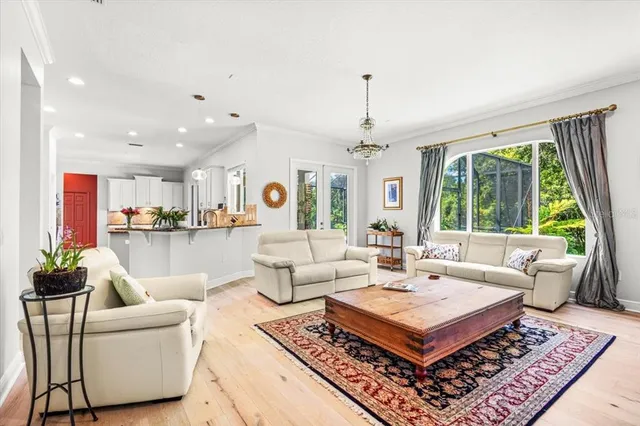 a living room with furniture a table and a large window