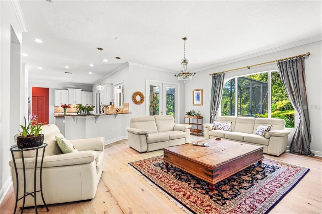 a living room with furniture a table and a large window