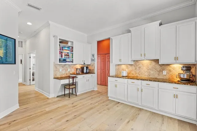 a kitchen with granite countertop white cabinets and white appliances