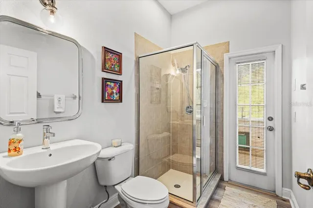 a bathroom with a sink toilet and shower