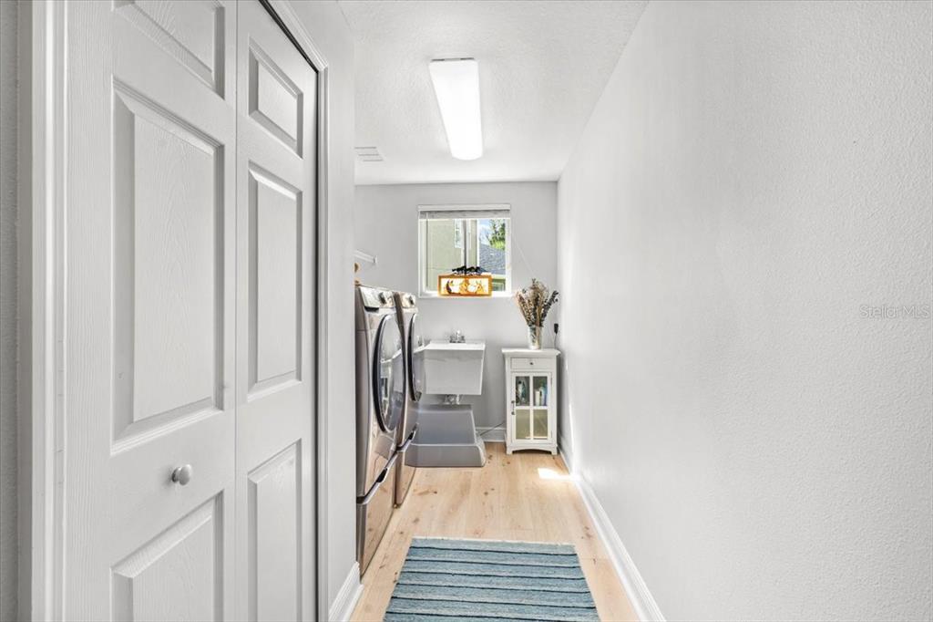 5120 Tari Stream Way Brandon, FL 33511 - Photo 18 of 35 a view of a hallway with wooden floor and staircase