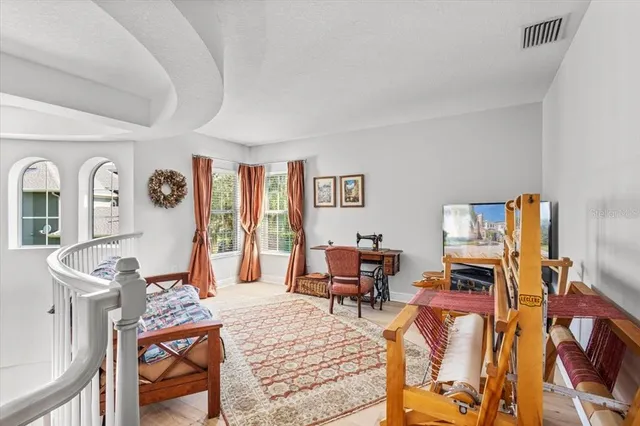 a living room with furniture and a piano