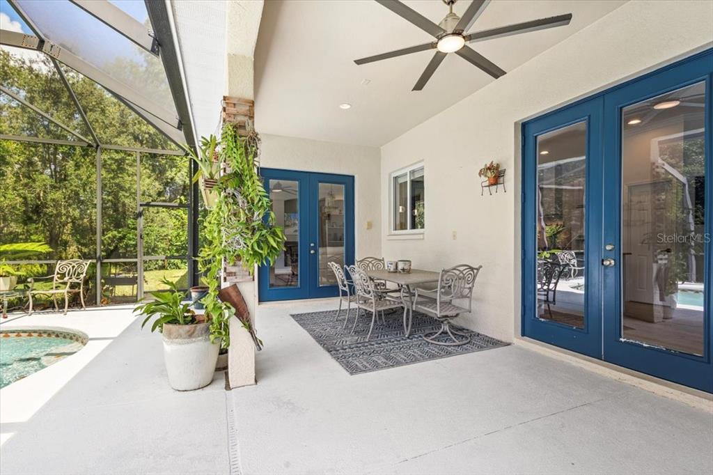5120 Tari Stream Way Brandon, FL 33511 - Photo 28 of 35 a dining room with chandelier fan and wooden floor