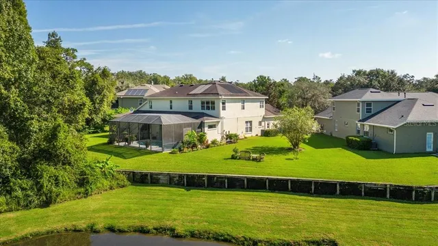 a view of a house with a yard and sitting area