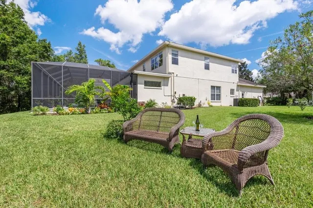 a view of a house with backyard sitting area and garden