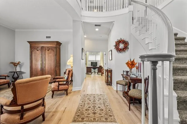 a living room with furniture and a chandelier