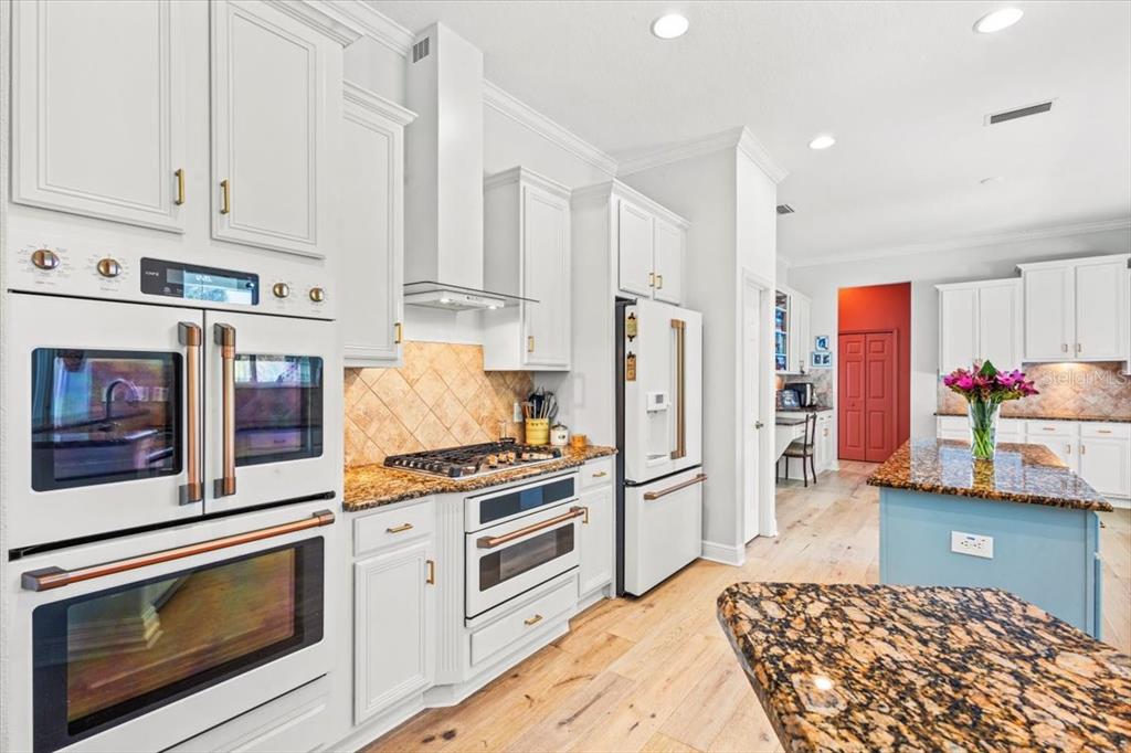 5120 Tari Stream Way Brandon, FL 33511 - Photo 8 of 35 a kitchen with stainless steel appliances granite countertop a refrigerator stove and white cabinets