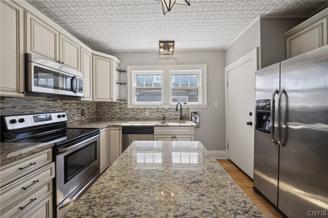 411 Robineau Road Syracuse, NY 13207 - Photo 19 of 50 Sleek granite countertops on custom cabinetry.