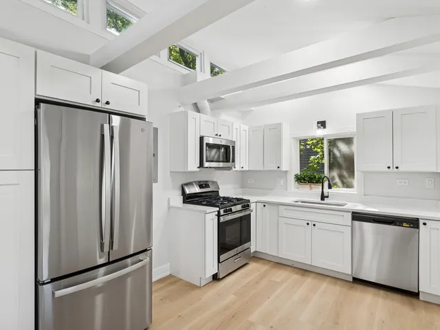 a kitchen with stainless steel appliances a refrigerator stove and sink