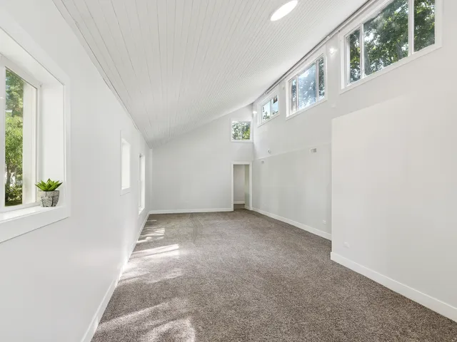 a view of an empty room with windows