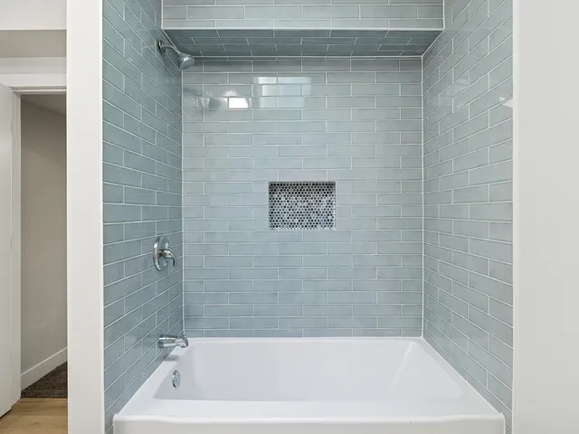 a bath tub sitting next to a shower