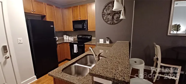 a bathroom with a granite countertop double vanity sink and a mirror
