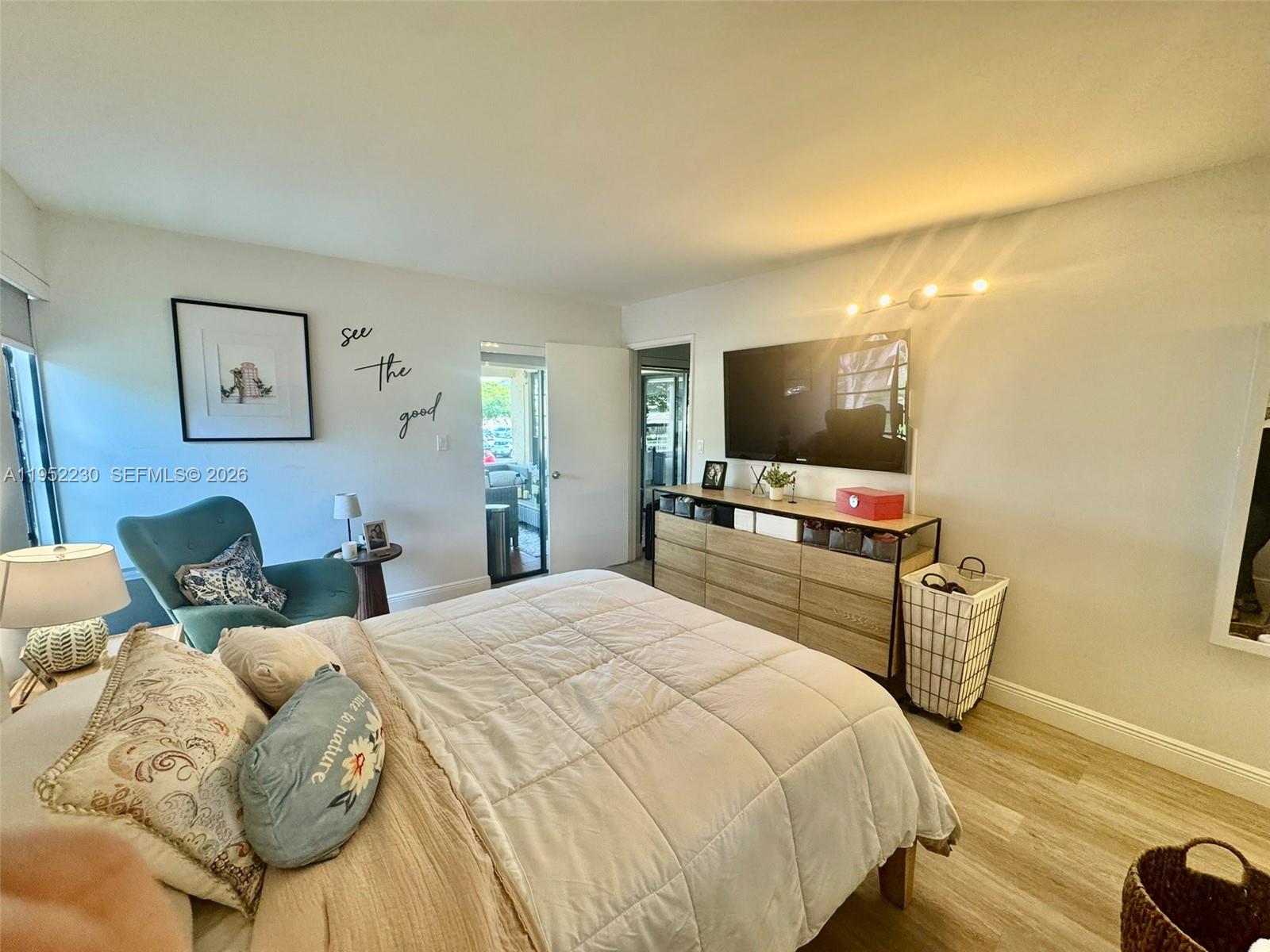 8810 Southwest 123rd Court, Unit M202 Miami, FL 33186 - Photo 17 of 34 a bedroom with a bed and a flat screen tv