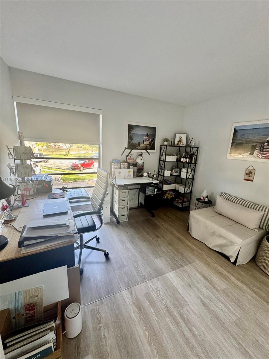 8810 Southwest 123rd Court, Unit M202 Miami, FL 33186 - Photo 24 of 34 a living room with furniture and a wooden floor
