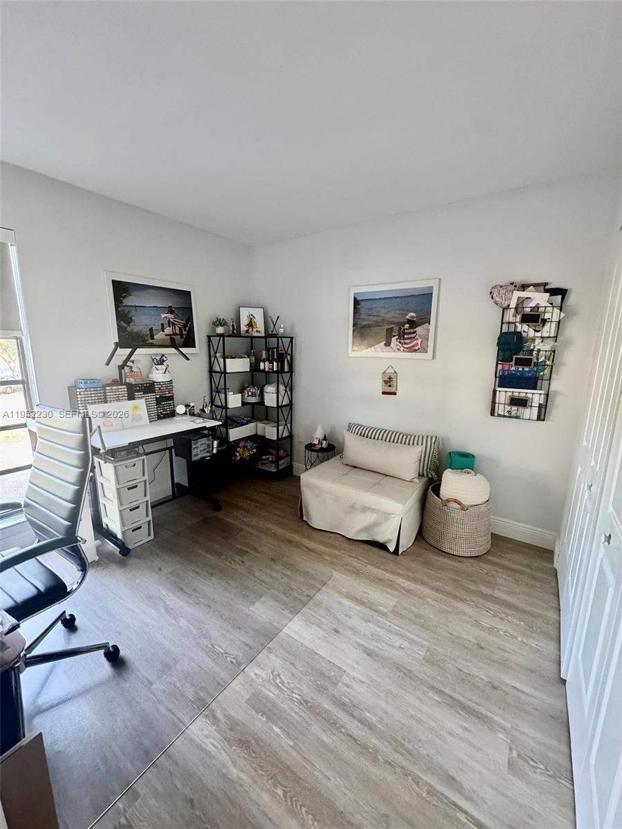 8810 Southwest 123rd Court, Unit M202 Miami, FL 33186 - Photo 25 of 34 a bedroom with furniture and a wooden floor