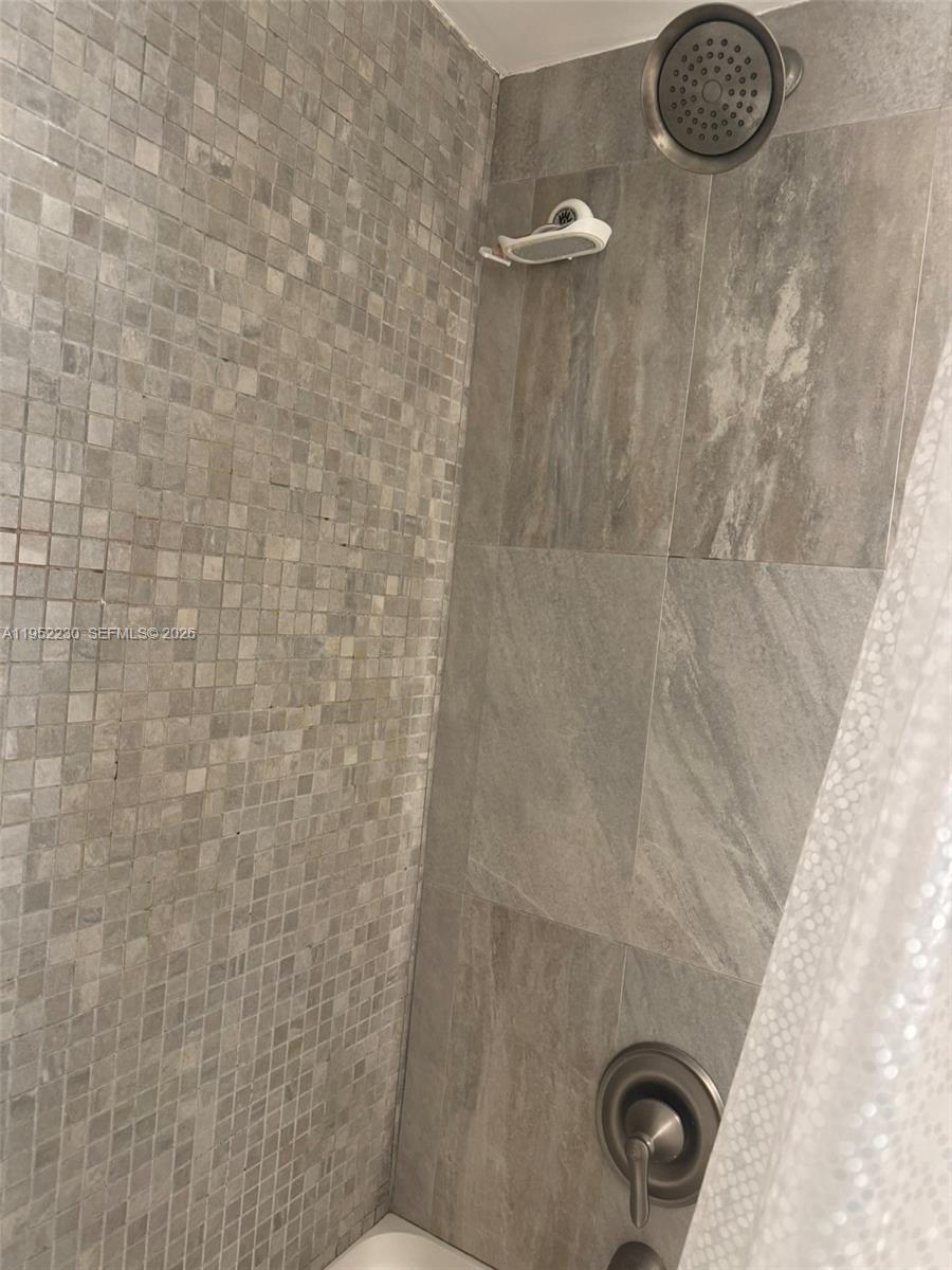8810 Southwest 123rd Court, Unit M202 Miami, FL 33186 - Photo 30 of 34 a bathroom with a shower