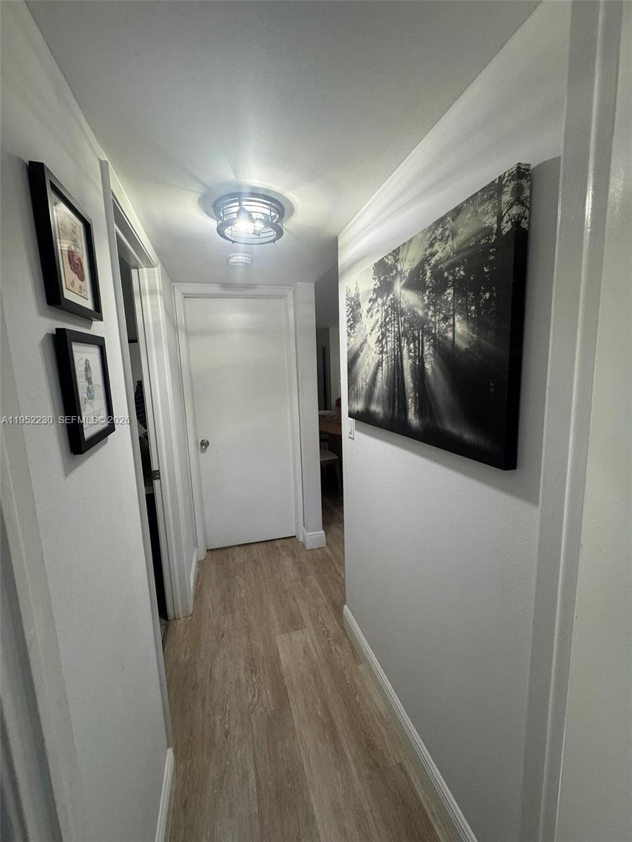 8810 Southwest 123rd Court, Unit M202 Miami, FL 33186 - Photo 31 of 34 a view of gallery with wooden floor