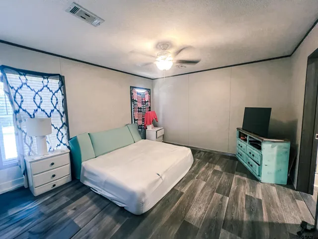 a bedroom with a bed and a flat screen tv