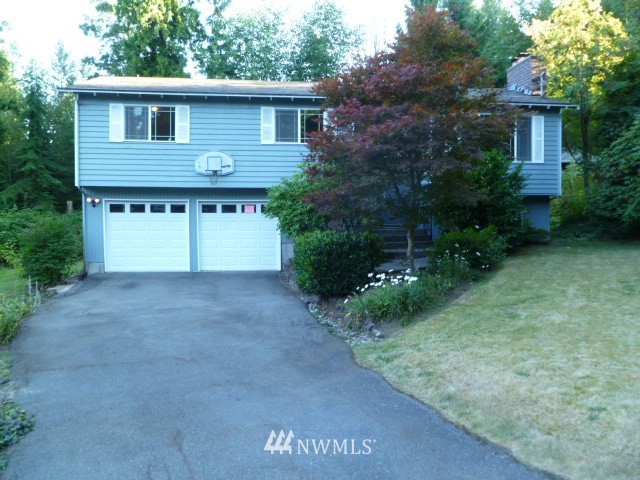 6224 226th Street Southeast Bothell, WA 98021 - Photo 1 of 1 a front view of a house with a yard and garage
