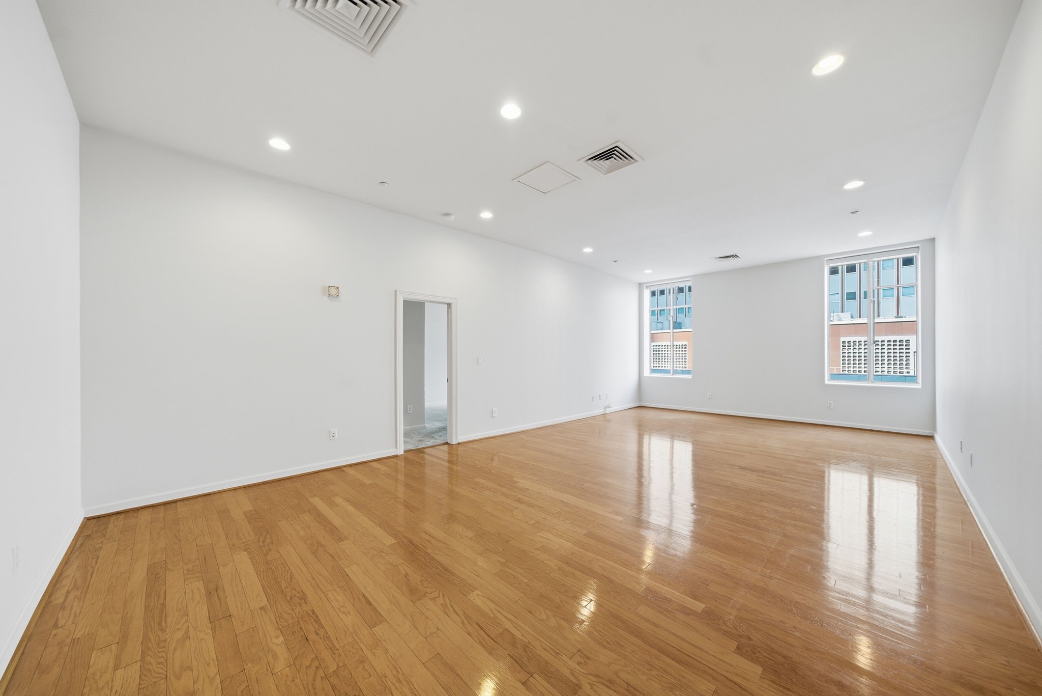 914 Main Street, Unit 704 Houston, TX 77002 - Photo 4 of 22 a view of an empty room with wooden floor and a window