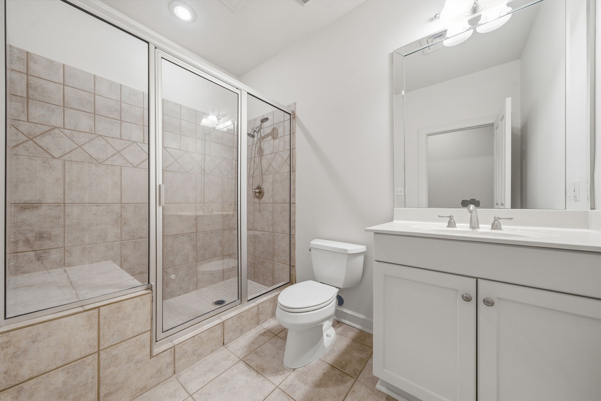 914 Main Street, Unit 704 Houston, TX 77002 - Photo 9 of 22 a bathroom with a shower sink mirror and toilet